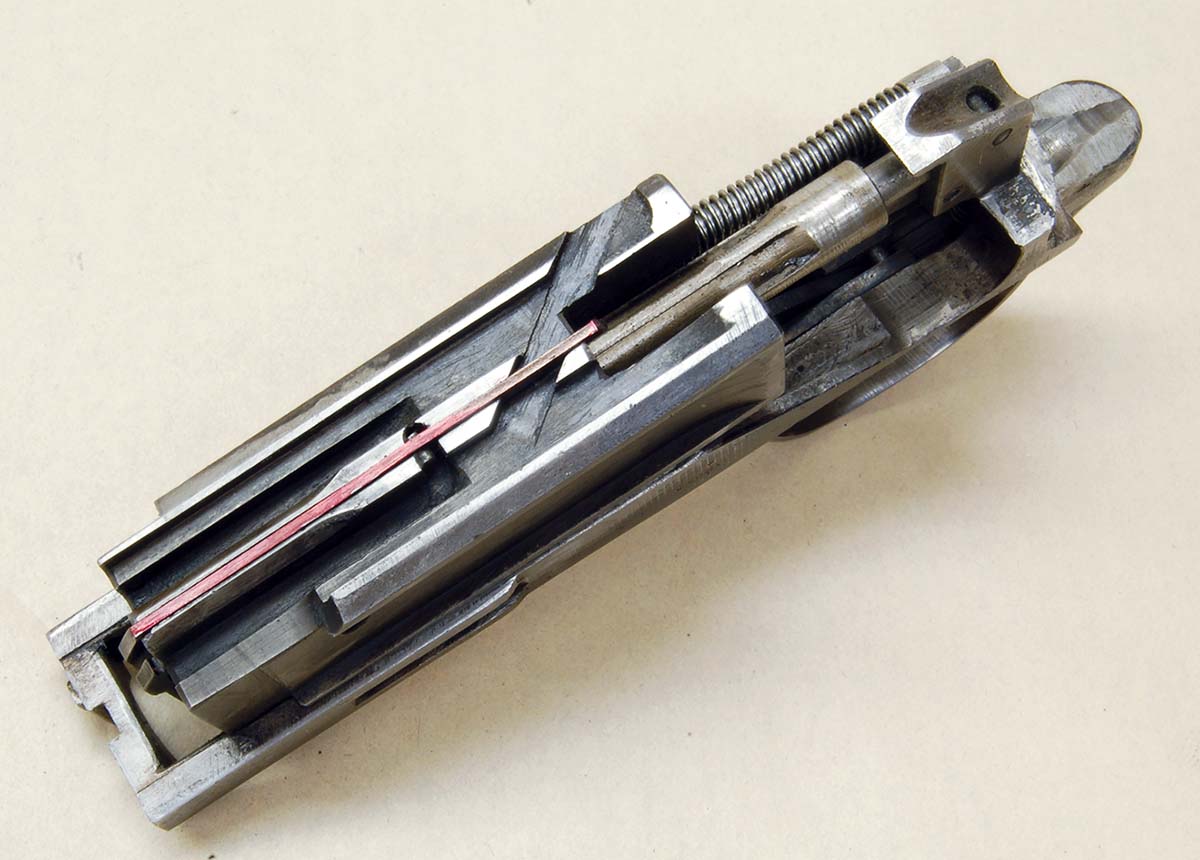 The ejector is the part colored red. Be careful removing the breechblock as the ejector can fall out.